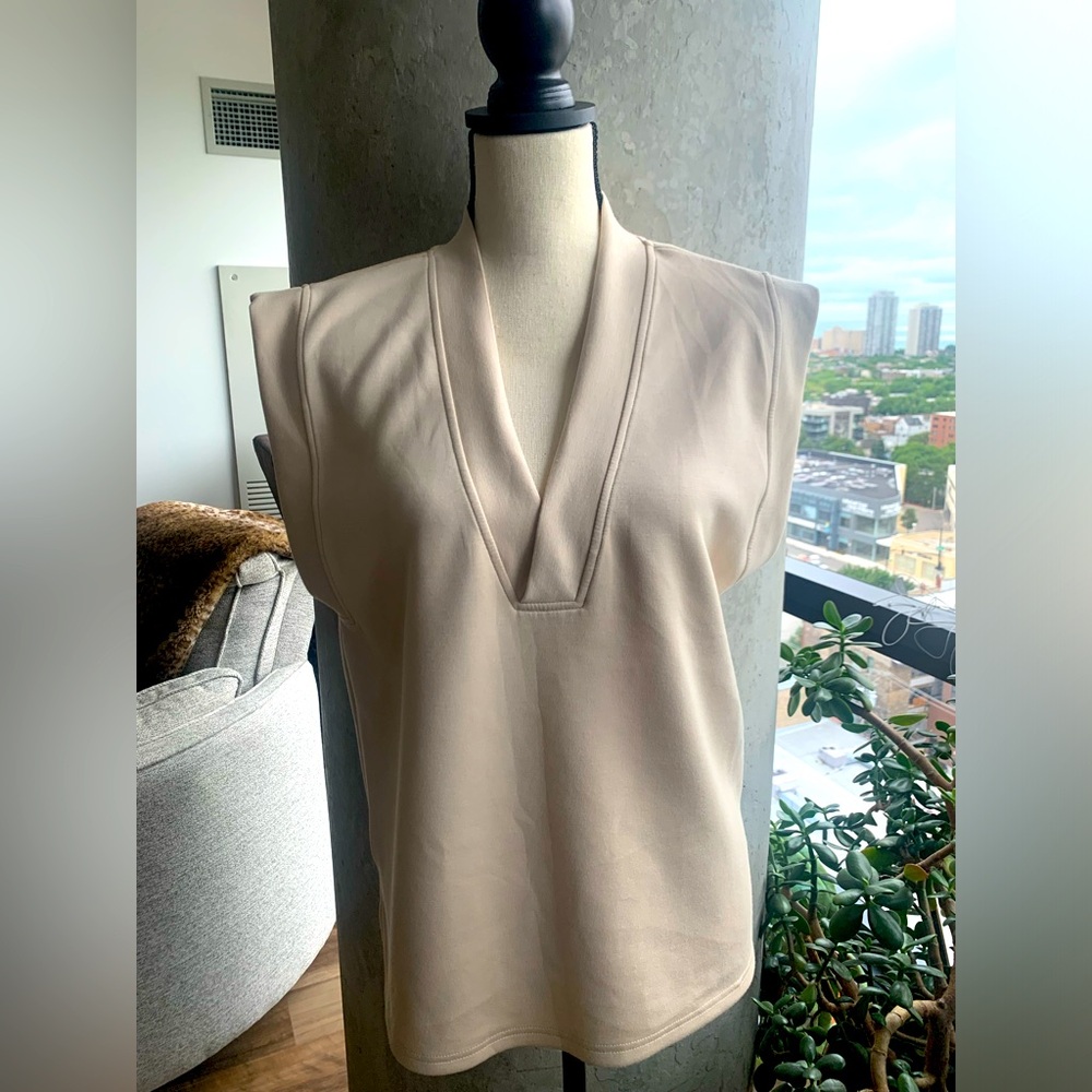 B. Young beige, lightweight vest.  Only worn once!